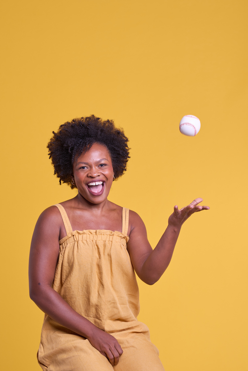 Bold & Punchy Headshots Portrait of Woman Throwing Baseball